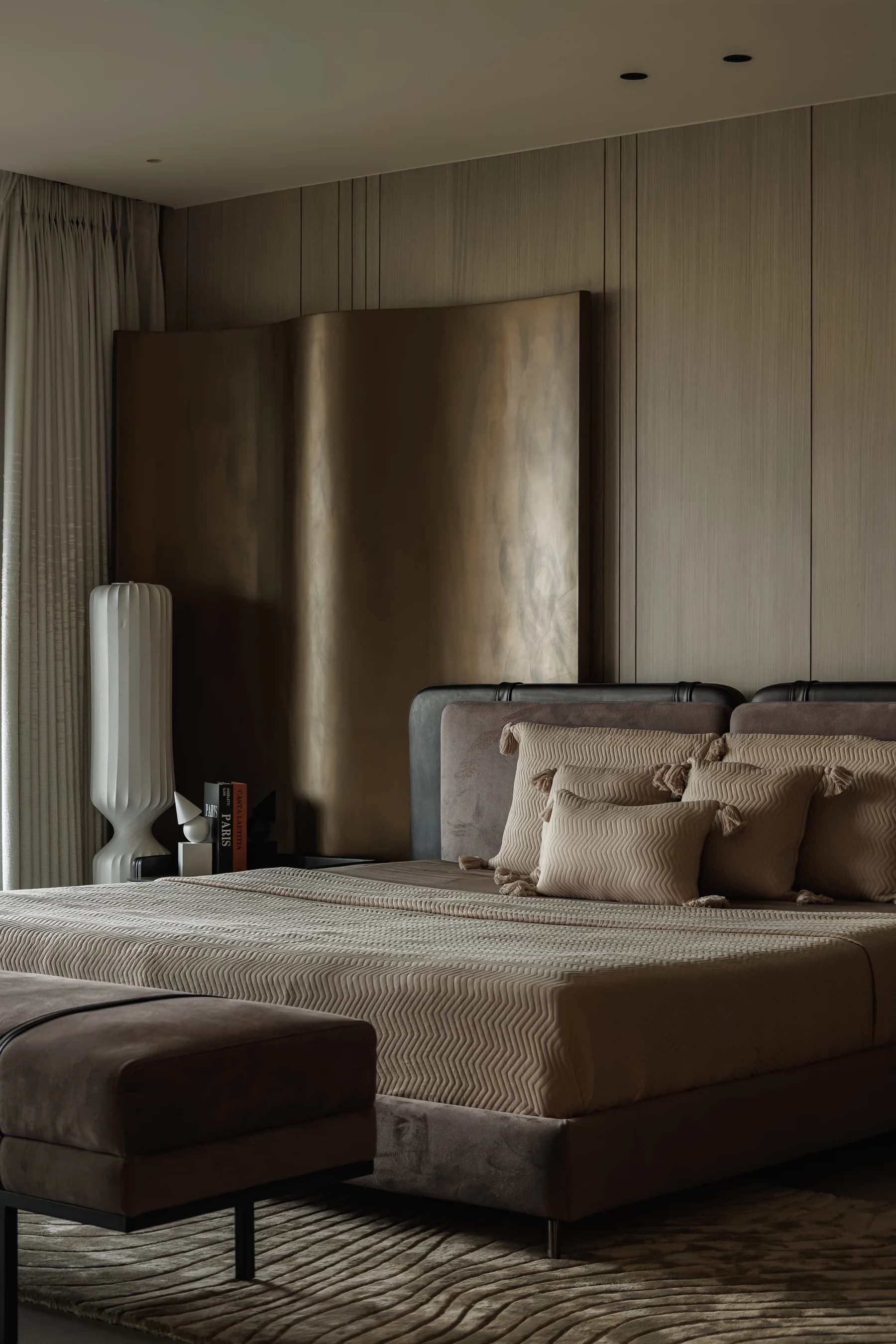 Bedroom with a brushed brass headboard wall